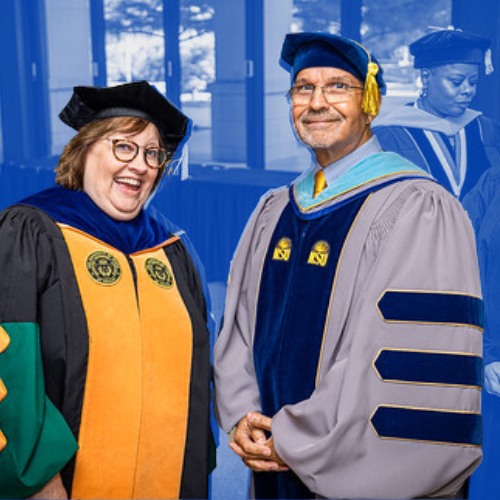 Two faculty members posing and smiling at the camera.
