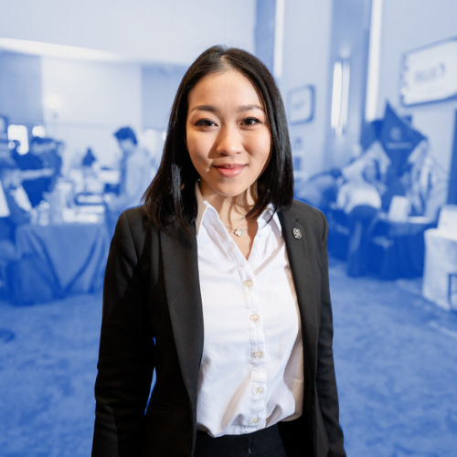 Woman dressed professionally and smiling at the camera. 