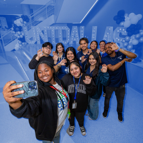 Ten students posing in front of UNT Dallas letters for a selfie. 