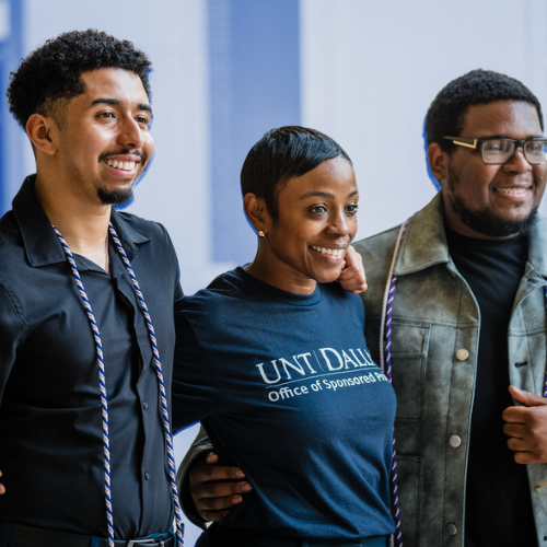 Three individuals (two men and one woman) all posing and smiling for the camera.