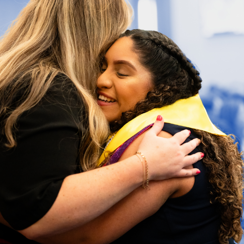 Two women hugging at the Ring and Cord Ceremony.