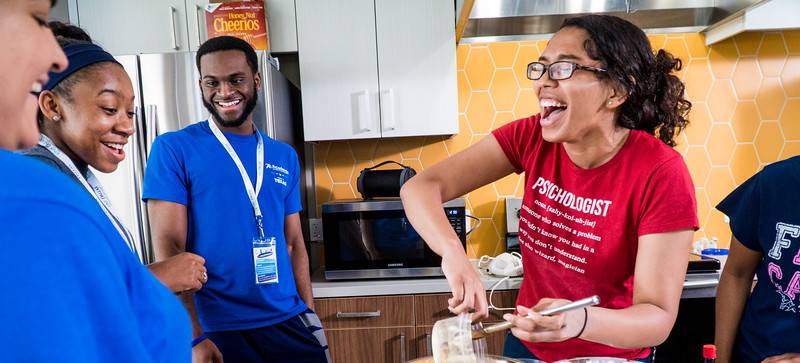 students baking in shared kitchen