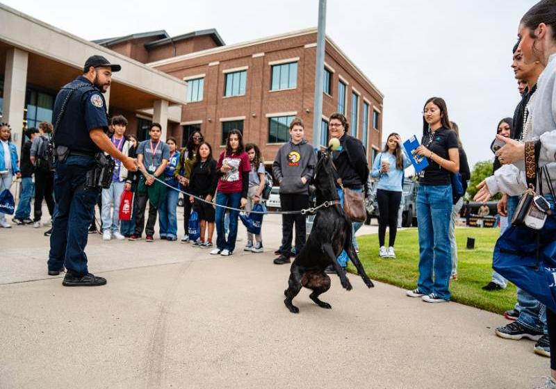A Four-Legged Officer Interacts with Students as His Two-Legged Partner Holds Onto the Leash