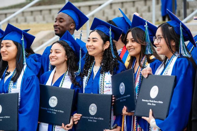Graduates Hold Their Diplomas and Celebrate Following the Fall 2025 Commencement Ceremony