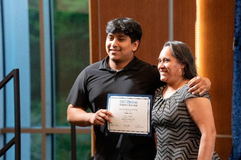 A Business Graduate Poses with His Mother After Receiving an Award at the School's Annual Banquet