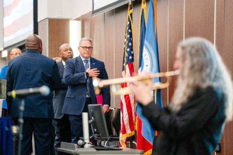 President Warren von Eschenbach and COO Dr. Rodney McClendon Listen to the National Anthem, Played by Patrick Brink