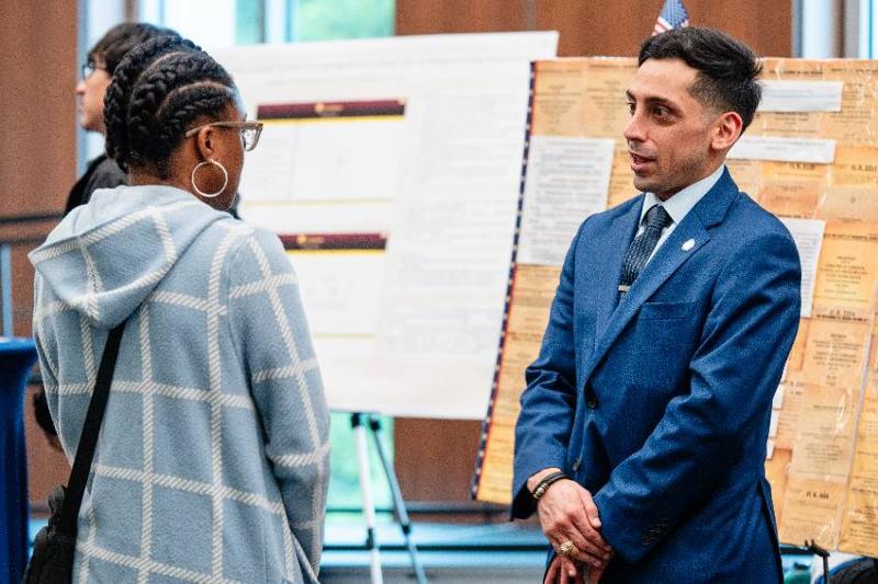 Noe Mendoza Jr Speaks with a Student About His Research Into Federal Regulations of the Boxing Industry