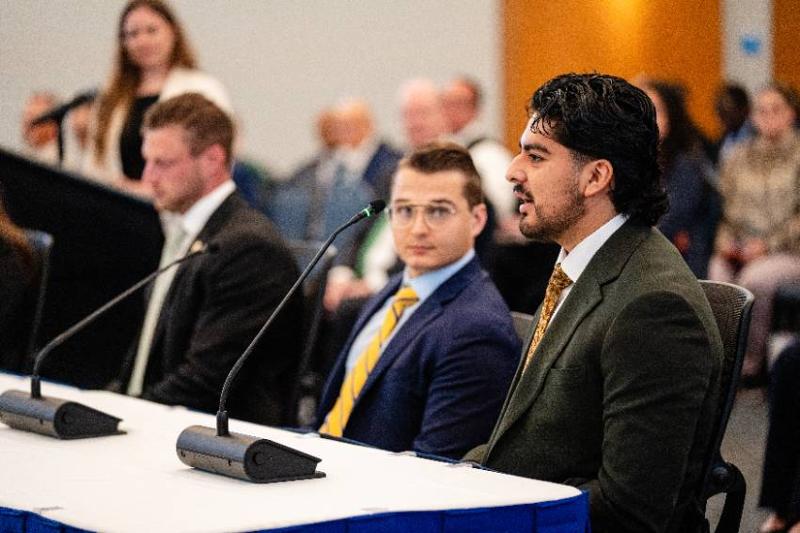 Third Year Law Student Isaac Torrez Speaks as Classmate Charles Keith, Graduate Andrew Brown and Professor Van Stean Listen