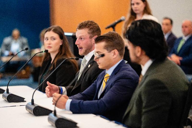2026 College of Law Graduate Andrew Brown Speaks to the UNT System Board of Regents as Victoria Saucedo, Charles Keith, Isaac Torrez and Professor Allie Van Stean Listen