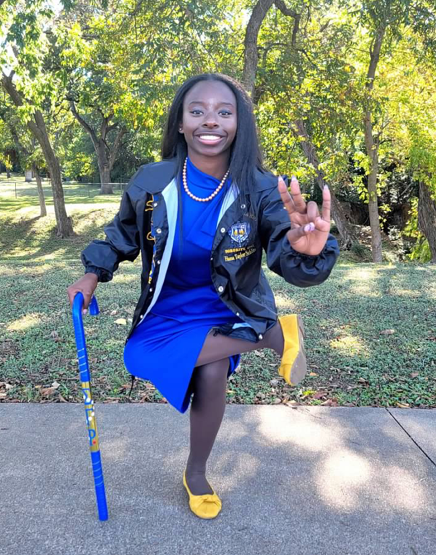 Hana Shows Her Fun Side While Posing on One Leg with Cane in Hand