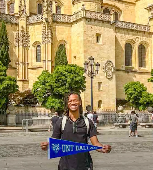 Jesstyn Baker Showing His UNT Dallas Pride While Visiting a Historic Building in Spain