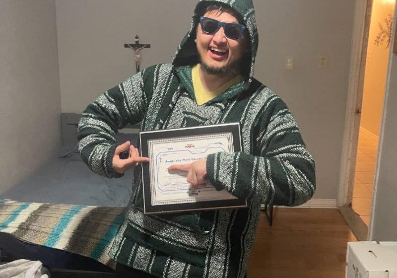 Jonathan Suarez Holding His "Most Valuable Player" Award as Selected by His eSports Teammates