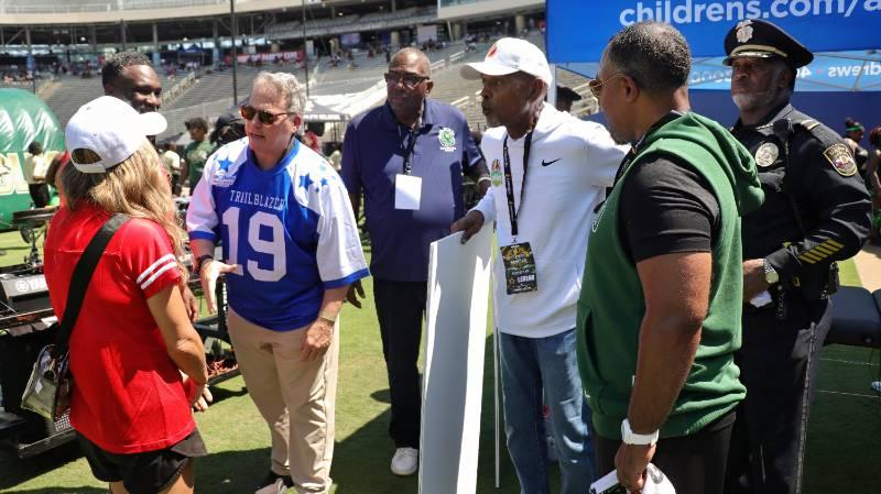 President Warren von Eschenbach, PhD, with Sen. Royce West and Roland G. Parrish at the Cotton Bowl on Saturday, Sept. 12, 2026