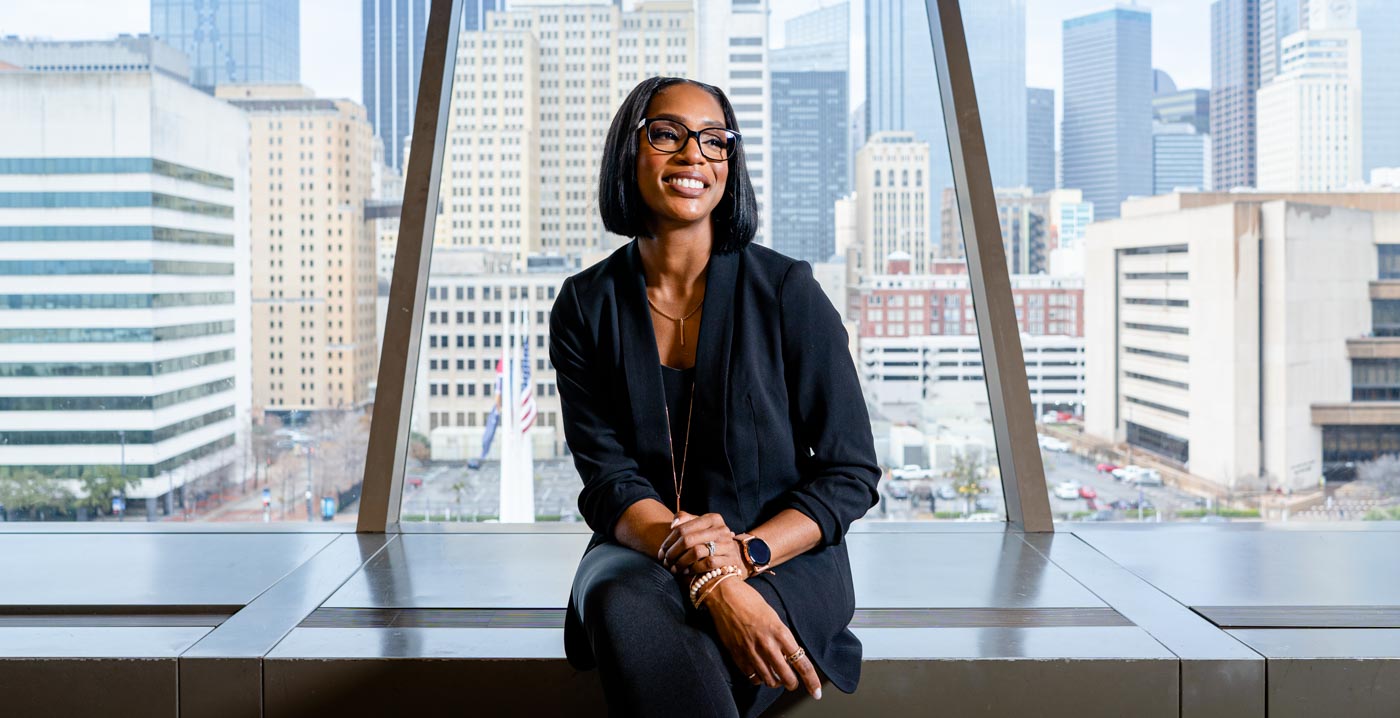 female in business attire with downtown background