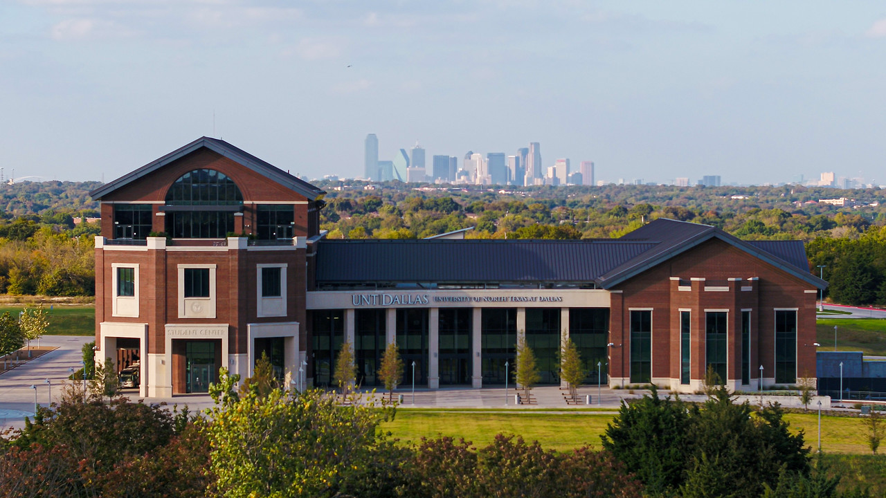 aerial of UNT Dallas Student Center with Dallas city skyline in the background