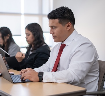 professionaly dressed student at desk