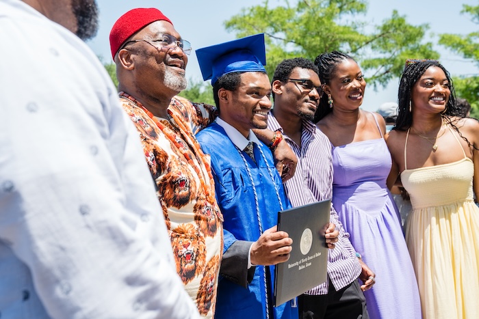 graduate with family outside venue