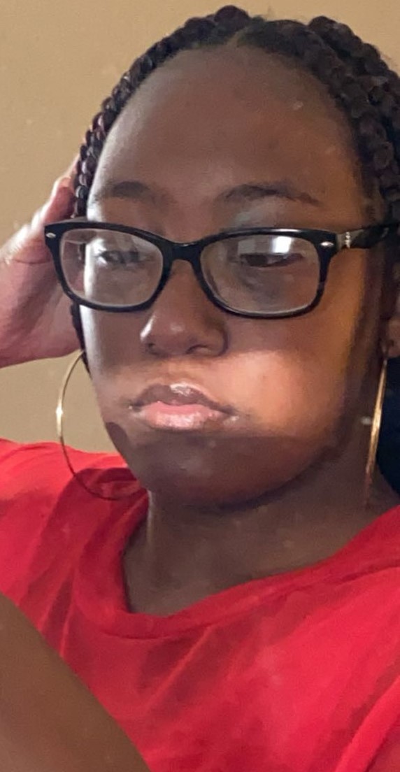 african american woman in red shirt and glasses