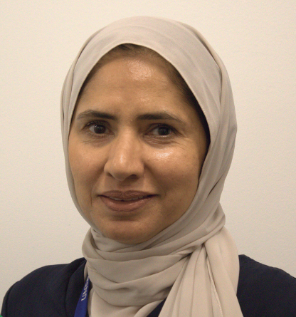 smiling woman wearing a tan scarf